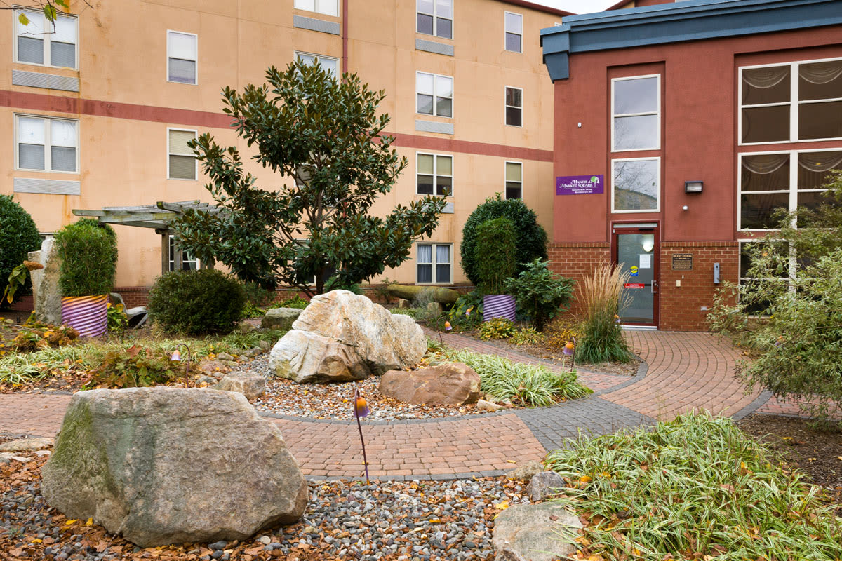 Landscaped courtyard with rocks and brick pathway